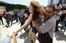 Police officers detain a FEMEN activist during a protest against the arrest of their Tunisian member named Amina, in Tunis