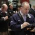 Michael Urkonis, right, works with fellow traders on the floor of the New York Stock Exchange, Friday, March 9, 2012. Stocks rose Friday morning after the February jobs report bolstered hopes that the economic recovery is on track. (AP Photo/Richard Drew)
