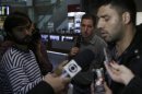 U.S. journalist Greenwald looks on as his partner Miranda talks with the media after arriving at Rio de Janeiro's International Airport