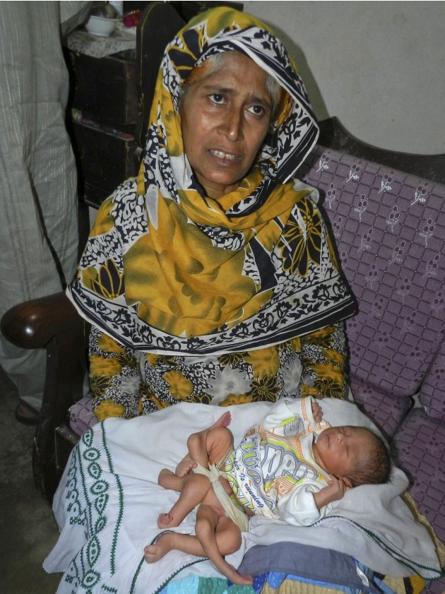 A woman holds her newly-born …