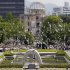 Doves fly by the gutted Atomic Bomb Dome, center in background, preserved as a landmark for the tribute to the A-Bomb attack, following a speech delivered by Prime Minister Naoto Kan, marking the 66th anniversary of the world's first atomic bombing, at Hiroshima Peace Memorial Park in Hiroshima, western Japan, Saturday, Aug, 6, 2011. (AP Photo/Koji Sasahara)