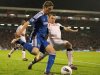 Chelsea striker Fernando Torres (L) attempts a cross under pressure from Fulham defender John Arne Riise (R