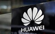 A Huawei logo is seen above the company's exhibition pavilion during the CommunicAsia information and communications technology trade show in Singapore June 19, 2012. REUTERS/Tim Chong