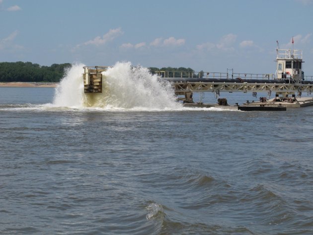 Water gets churned up at the end of a dredging pipeline connected to a U.S. Army Corps of Engineers' dredge on the Mississippi River on Monday, Aug. 20, 2012 near Memphis, Tenn. Sand that is removed f