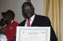 Former soccer star George Weah holds up a certificate of election after being elected senator in Monrovia