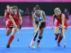 Argentina's Aymar controls ball between Great Britain's Bartlett and Twigg during their women's semifinal hockey match at Riverbank Arena at London 2012 Olympic Games