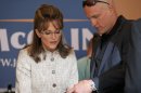 In this undated image released by HBO, Julianne Moore portrays Sarah Palin, left, and Woody Harrelson portrays campaign strategist Steve Schmidt in a scene from 
