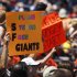 A fan in the center of a section of San Francisco Giants' fans holds up a sign during a baseball game against the San Diego Padres, Sunday, Aug. 19, 2012, in San Diego. Melky Cabrera, one of the Gaints' top hitters, was suspended this week for failing a drug test. (AP Photo/Lenny Ignelzi)