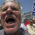 FILE - In this July 19, 2011 file picture a striking taxi driver shouts anti-government slogans outside the Greek Parliament in Athens, during a protest about the European financial crisis. After a turbulent 2011, the 17 countries that use the euro will be quickly confronted in the new year with major hurdles to solving their government debt crisis, just as the eurozone economy is expected to sink back into recession. With government finances under pressure as growth wanes, the eurozone will find it even more difficult to shore up shaky banks and reduce the high borrowing costs that threaten Italy and Spain with financial ruin.  As early as the second full week of January, bond auctions in which Italy and Spain need to borrow big chunks of cash will start showing whether the eurozone is finally getting a grip on the 2-year-old crisis that has seen Greece, Ireland and Portugal bailed out. (AP Photo/Dimitri Messinis,File)