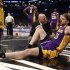 Los Angeles Lakers' Gasol sits on the floor with a member of the Lakers medical staff after suffering an injury to his right leg in the fourth quarter of their NBA basketball game against the Brooklyn