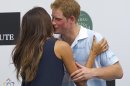 Britain's Prince Harry greets Brazilian model Fernanda Motta during an award ceremony after playing a charity polo match in Campinas, Brazil, Sunday March 11, 2012. Prince Harry is in Brazil at the request of the British government on a trip to promote ties and emphasize the transition from the upcoming 2012 London Games to the 2016 Olympics in Rio de Janeiro. (AP Photo/Andre Penner)