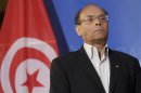 Tunisia's President Marzouki listens his national anthem during arrivals at the European Parliament in Strasbourg