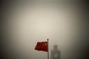 File photo of a Chinese national flag flying in front of Beijing Telegraph Building on a hazy morning in central Beijing