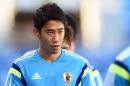 Japan's forward Shinji Kagawa walks on the pitch during an official training session at The Pantanal Arena in Cuiaba on June 23, 2014