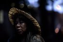 An indigenous woman participates in a protest at a building known as the "Old Indian Museum," located near the Maracana stadium in Rio de Janeiro, Brazil, during the United Nations Conference on Sustainable Development, or Rio+20, Thursday June 21, 2012. Indigenous people who have built homes at the building will be relocated due to works on the stadium and the surrounding area as part of Brazil's preparations for the 2014 World Cup. (AP Photo/Felipe Dana)