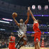 San Antonio Spurs center Boris Diaw (33) shoots over Chicago Bulls center Joakim Noah (13) as forward Luol Deng watches during the first half of an NBA basketball game, Monday, Feb. 11, 2013, in Chicago. (AP Photo/Charles Rex Arbogast)