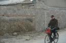 A local resident cycles past the demolished Tianyi Inn in Beijing, on January 7, 2014