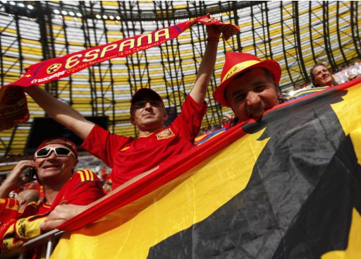 Spanish fans cheer with the national flag as they wait for the start of the Group C Euro 2012 soccer match against Italy in PGE Arena in Gdansk
