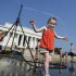 Sophie, 3, from Connecticut, frolics with a water sprinkler set up at the National Mall near the Lincoln Memorial, rear, in Washington Saturday, July 7, 2012.  The heat gripping much of the country is set to peak Saturday in many places, including some Northeast cities, where temperatures close to or surpassing 100 degrees are expected. (AP Photo/Manuel Balce Ceneta)