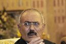 FILE - In this Saturday, Dec. 24, 2011 file photo, Yemen's President Ali Abdullah Saleh speaks to reporters during a press conference at the Presidential Palace in Sanaa, Yemen. Gunmen loyal to Yemen's ousted president blasted buildings at the country's main airport with anti-aircraft guns on Saturday, forcing authorities to shut it down, an airport official said. The attack comes a day after Yemen's new President Abed Rabbo Mansour Hadi fired key security officials appointed by ex-president Ali Abdullah Saleh including his half brother, the air force commander Mohammed Saleh al-Ahmar, and his nephew, Tariq, who headed the presidential guard. (AP Photo/Mohammed Hamoud, File)