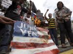 Protesters burn a mock American flag during a rally at the U.S. Embassy in Manila to protest the recent incident in the Philippines wherein a U.S. Navy minesweeper, USS Guardian, ran aground off Tubbataha Reef, a World Heritage Site in the Sulu Sea, 640 kilometers (400 miles) southwest of Manila, Philippines Saturday Jan. 19, 2013. The protesters are demanding the abrogation of the Visiting Forces Agreement which allows U.S. troops' presence in the country.  (AP Photo/Bullit Marquez)