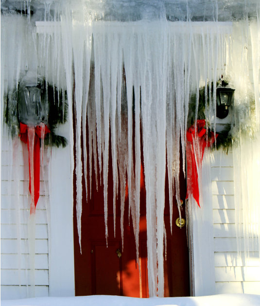Icicles block the front door of a farm house, Monday, Jan. 24, 2011 in Canterbury, N.H.  as temperatures drop below zero overnight.  (AP Photo/Jim Cole)