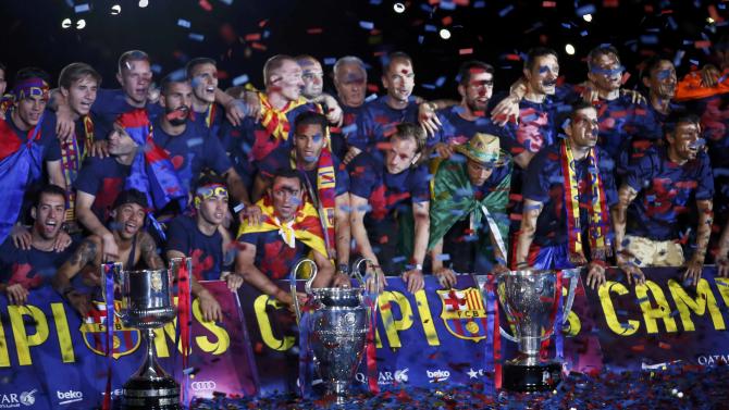 Barcelona&#39;s players and staff members pose with their trophies during celebration parade in Barcelona