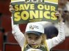 Seattle Supersonics fan Rydberg holds up a "SOS: Save our Sonics" sign before the start of their NBA game against the Dallas Mavericks in Seattle