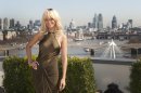 Rihanna poses for photographers in front of a London skyline atop a central London hotel during a photocall for the film 'Battleship', Wednesday, March 28, 2012. (AP Photo/Joel Ryan)