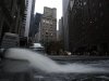 Water gushes from a hose as it is pumped out of a basement in New York's financial district, Wednesday, Oct. 31, 2012. Much of lower Manhattan and the financial district are still without electrical power. The Federal Reserve Bank of New York is background center. (AP Photo/Mark Lennihan)