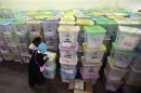 Polling clerks record information on a pile of ballot boxes containing cast ballot papers at the Chandaria tallying centre in Kenya's coastal city of Mombasa