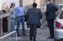 Captain Francesco Schettino, center with back to camera, arrives with his lawyer Francesco Pepe, right, at the court room of the converted Teatro Moderno theater for his trial, in Grosseto, Italy, Monday, Sept. 23, 2013. Schettino is charged with manslaughter, causing the shipwreck and abandoning the Costa Concordia before all aboard were evacuated after it crashed into a reef off the Tuscan island of Giglio in January 2012, killing 32 people. The trial of the captain of the ship resumed Monday after a two-month summer recess, during which a salvage operation took place to upright the wreck. (AP Photo/Andrew Medichini)