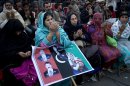 Supporters of Pakistan's assassinated leader Benazir Bhutto pray during her fifth death anniversary in Rawalpindi, Pakistan, Thursday, Dec. 27, 2012. The 24-year-old son of former Pakistani Prime Minister Benazir Bhutto has launched his political career at his ancestral place Larkana, with a fiery speech on the fifth anniversary of his mother's assassination. (AP Photo/B.K. Bangash)