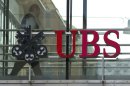 FILE - In thos June 22, 2012 file photo a man walks past the logo of the UBS bank in Zurich, Switzerland. UBS AG posted second-quarter net profits of 425 million Swiss francs (US$434.16 million) Tuesday, July 31, 2012, a sharp plunge from the 1.02 billion Swiss francs (US$1.2 billion) it posted in the comparable period a year ago. Hit by lower trading revenue and fewer commissions and client fees, Switzerland's largest bank said the 58 percent net profit drop reflects "challenging conditions marked by increased volatility and greater client caution." (AP Photo/Keystone, Alessandro Della Bella, File)