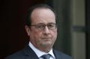 French President Francois Hollande waits for a guest at the Elysee palace in Paris, France