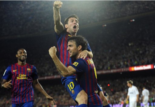 FC Barcelona's Lionel Messi from Argentina, second right reacts after scoring with his teammate Cesc Fabregas against Real Madrid during his Super Cup final second leg soccer match at the Camp Nou Stadium in Barcelona, Spain, Wednesday, Aug. 17, 2011. (AP Photo/Manu Fernandez)