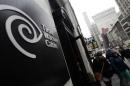 Pedestrians walk past the Time Warner Cable headquarters in New York