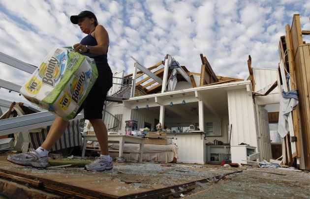 Denise Robinson clears out her destroyed beach home in the Sandbridge area of Virginia Beach after Hurricane Irene hit Virginia Beach, Va., Sunday, Aug. 28, 2011.  Officials speculate that a tornado s