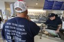 A cup of Peachy Paterno ice cream is scooped for a customer wearing a shirt memorializing former Penn State head football coach Joe Paterno at the Berkey Penn State Creamery on the main campus of Penn State University in State College, Pa., Friday, July 13, 2012. (AP Photo/Gene J. Puskar)