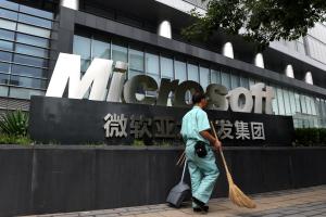 A cleaner walks past a Microsoft office building in&nbsp;&hellip;