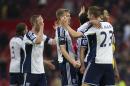 West Bromwich Albion players including captain Darren Fletcher, center, celebrate after their 1-0 win during the English Premier League soccer match between Manchester United and West Bromwich Albion at Old Trafford Stadium, Manchester, England, Saturday, May 2, 2015. (AP Photo/Jon Super)