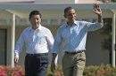 President Barack Obama, right, walks with Chinese President Xi Jinping at the Annenberg Retreat of the Sunnylands estate Saturday, June 8, 2013, in Rancho Mirage, Calif. During their walk President Obama told reporters his meetings with President Xi have been "terrific." The issue of cyber espionage hangs over the summit, although both leaders carefully avoided accusing each other of the practice. (AP Photo/Evan Vucci)