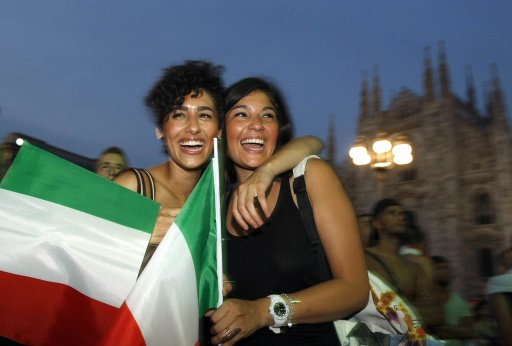 Fans celebrate after Balotelli scored against Germany during their Euro 2012 semi-final soccer match in Milan