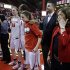 Rutgers head coach C. Vivian Stringer wipes a tear as she stands with athletic director Tim Pernetti and her team to celebrate Stringer's 900th career win in an NCAA college basketball game Tuesday, Feb. 26, 2013, in Piscataway, N.J., Rutgers defeated South Florida 68-56. (AP Photo/Mel Evans)