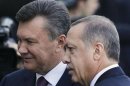 Ukrainian President Yanukovich stands with Turkey's PM Erdogan during a welcoming ceremony in Kiev