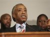 Reverend Al Sharpton speaks while flanked by Trayvon Martin's parents Tracy Martin and Sybrina Fulton during a press conference in response charges brought against George Zimmerman at the Washington Convention Center in Washington D.C.