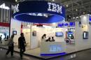 Visitors walk past the IBM booth at the 9th China International Software Product & Information Service Expo in Nanjing