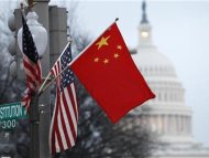 The People's Republic of China flag and the U.S. Stars and Stripes fly on a lamp post along Pennsylvania Avenue near the U.S. Capitol in Washington