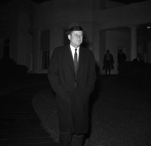 FILE - In this Dec. 19, 1961 file photo, President John F. Kennedy leaves the White House in Washington to Andrews Air Force Base for flight to Palm Beach, Fla. en route to the bedsite of his father, Joseph P. Kennedy, who is hospitalized after suffering as stroke. Kennedy's civil rights legacy has undergone substantial reassessment since his 1963 assassination. Half a century later, "We're still trying to figure it out," says one longtime civil rights activist. (AP Photo/WJS)