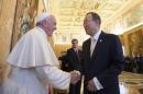 Pope Francis shakes hands with U.N. Secretary General Ban during a meeting at the Vatican
